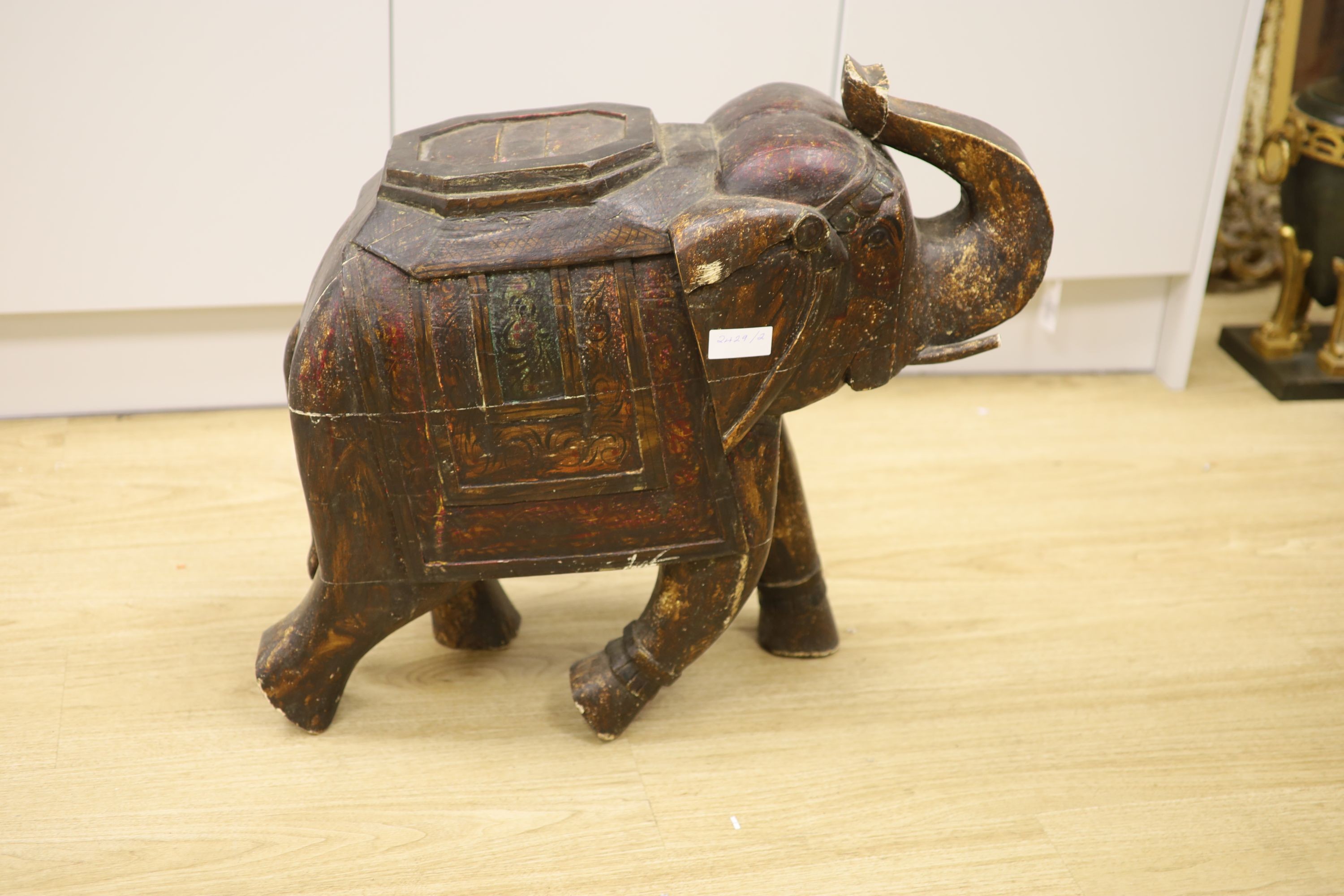 A large Indian painted and carved wood elephant figure, 59 cm high